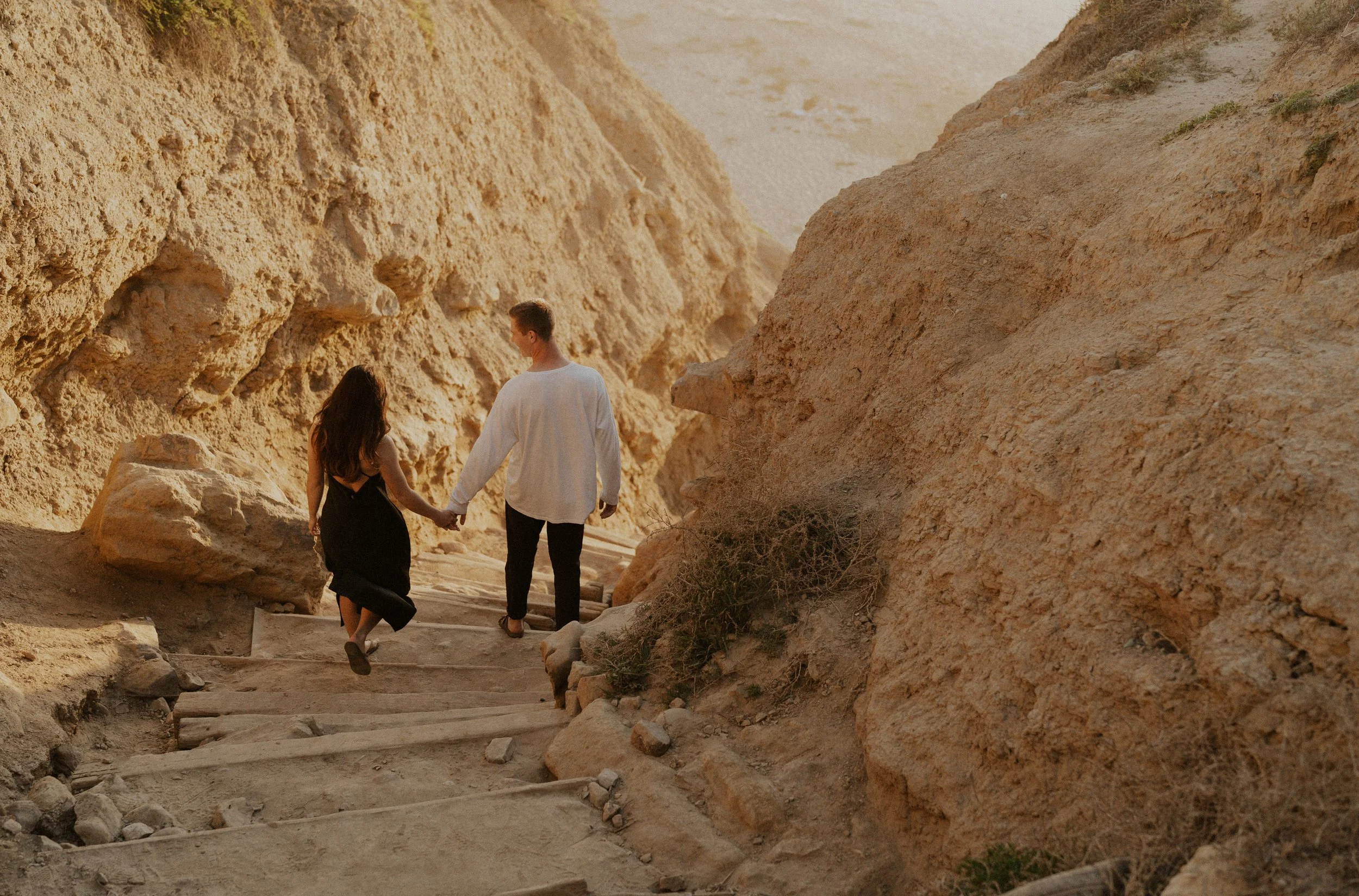 Married Couple Holding Hands While Walking Down Stairs | Torrey Pines Anniversary Session in San Diego