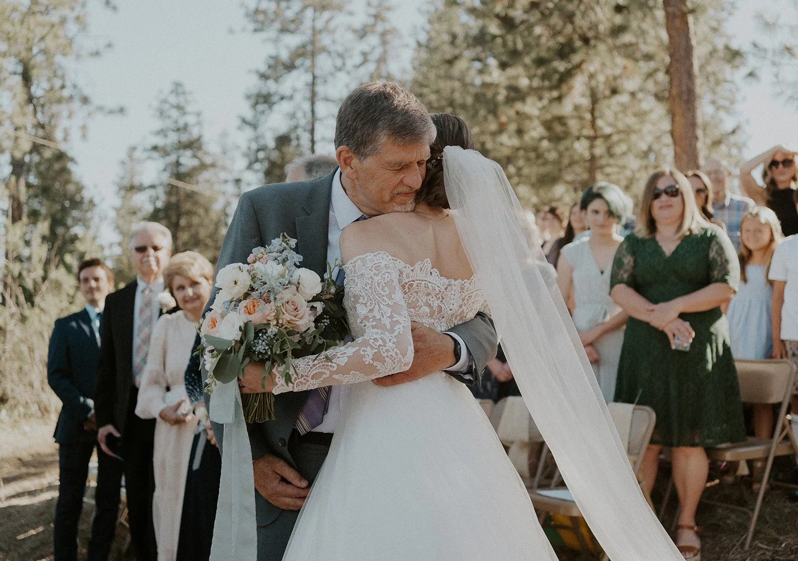 bride hugging father after walking down the aisle