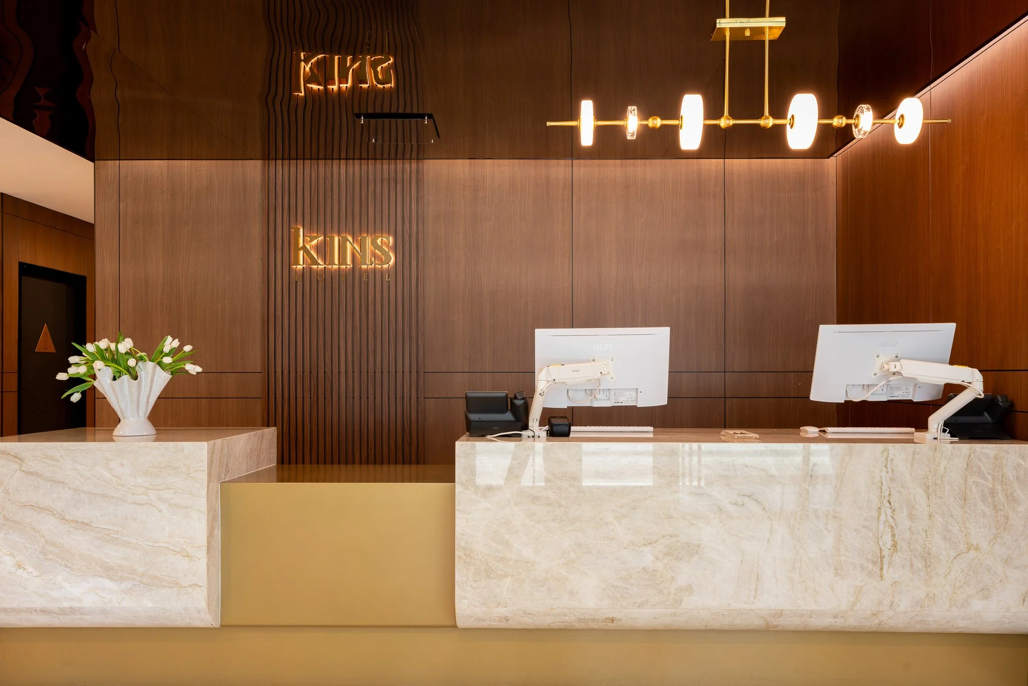 Beautiful lobby interior with computers and gold lighting for the Kins Hotel in Los Angeles