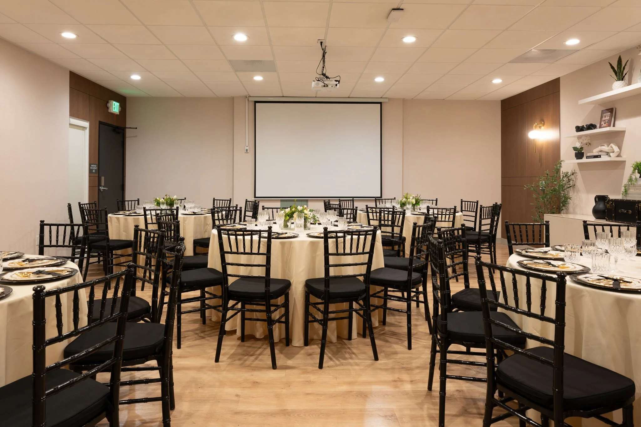 Beautiful event venue at a hotel with glasses and bouquets.