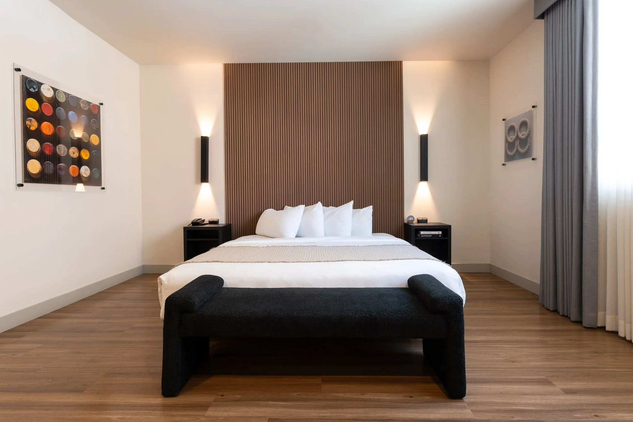 Beautiful deluxe suite bedroom with sconce lights on