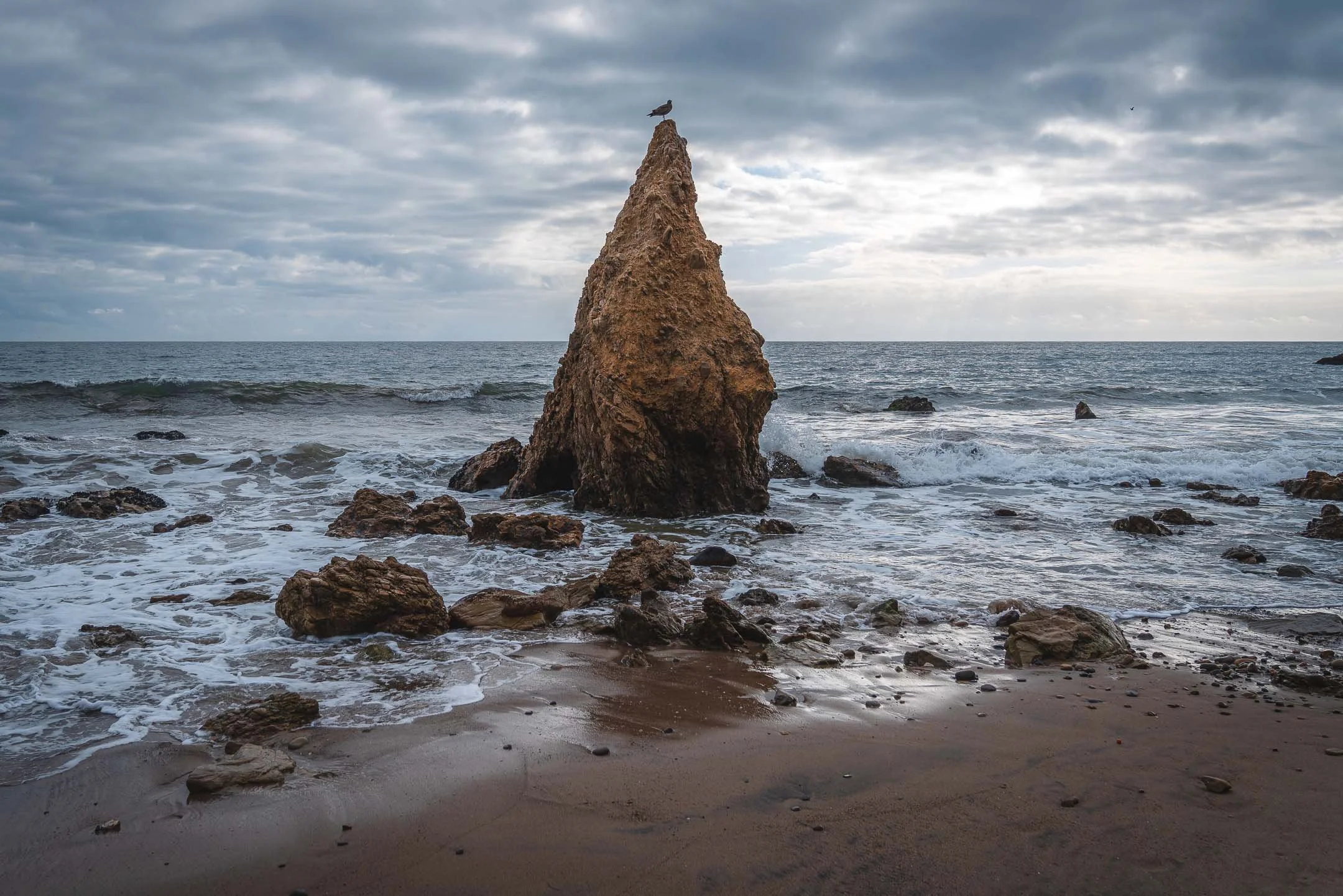 Dramatic clouds over the crashing waves in El Matador Beach