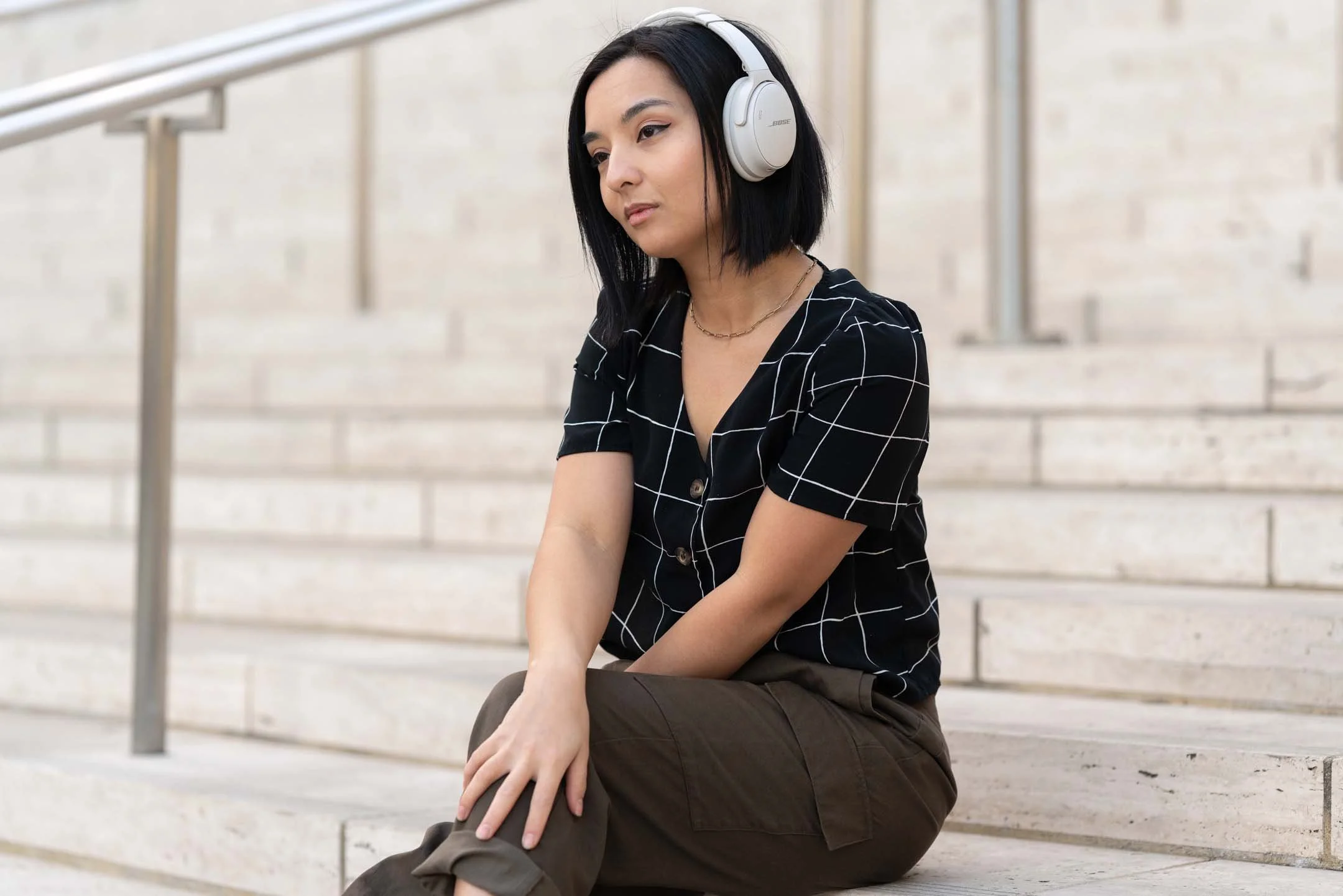 Model wearing white Bose headphones in Downtown Los Angeles
