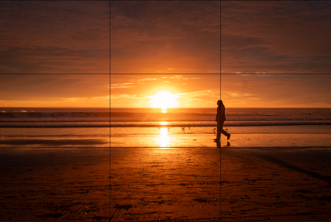 Woman walking on the beach with lower thirds grid displayed