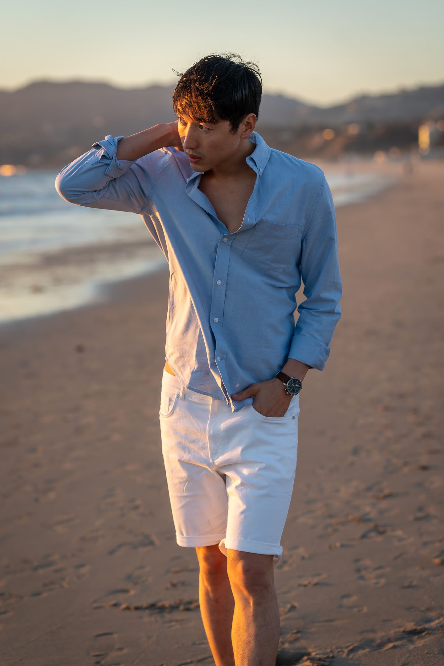 Los Angeles male model walking on beach with resortwear