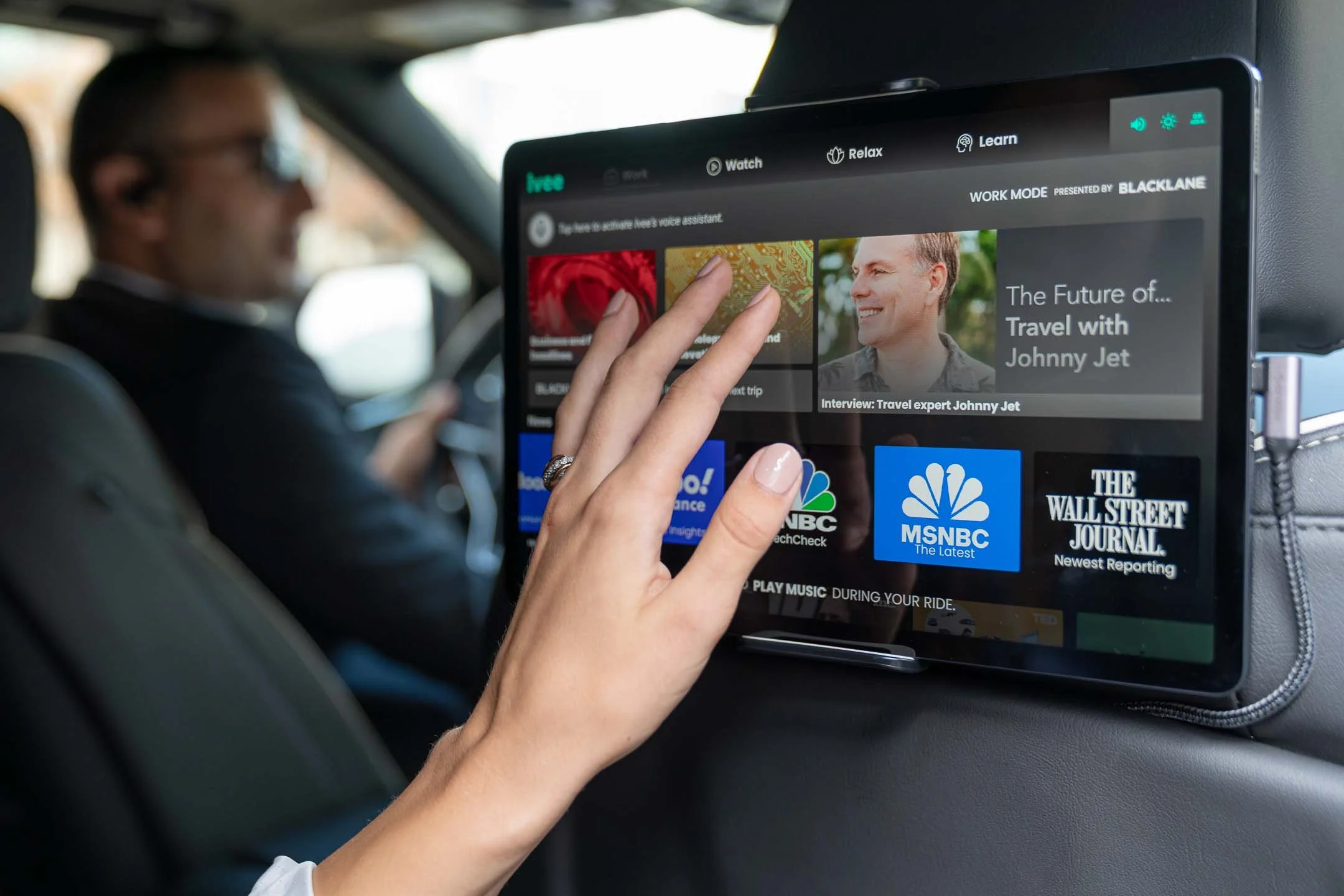 Woman using Ivee tablet in a limousine