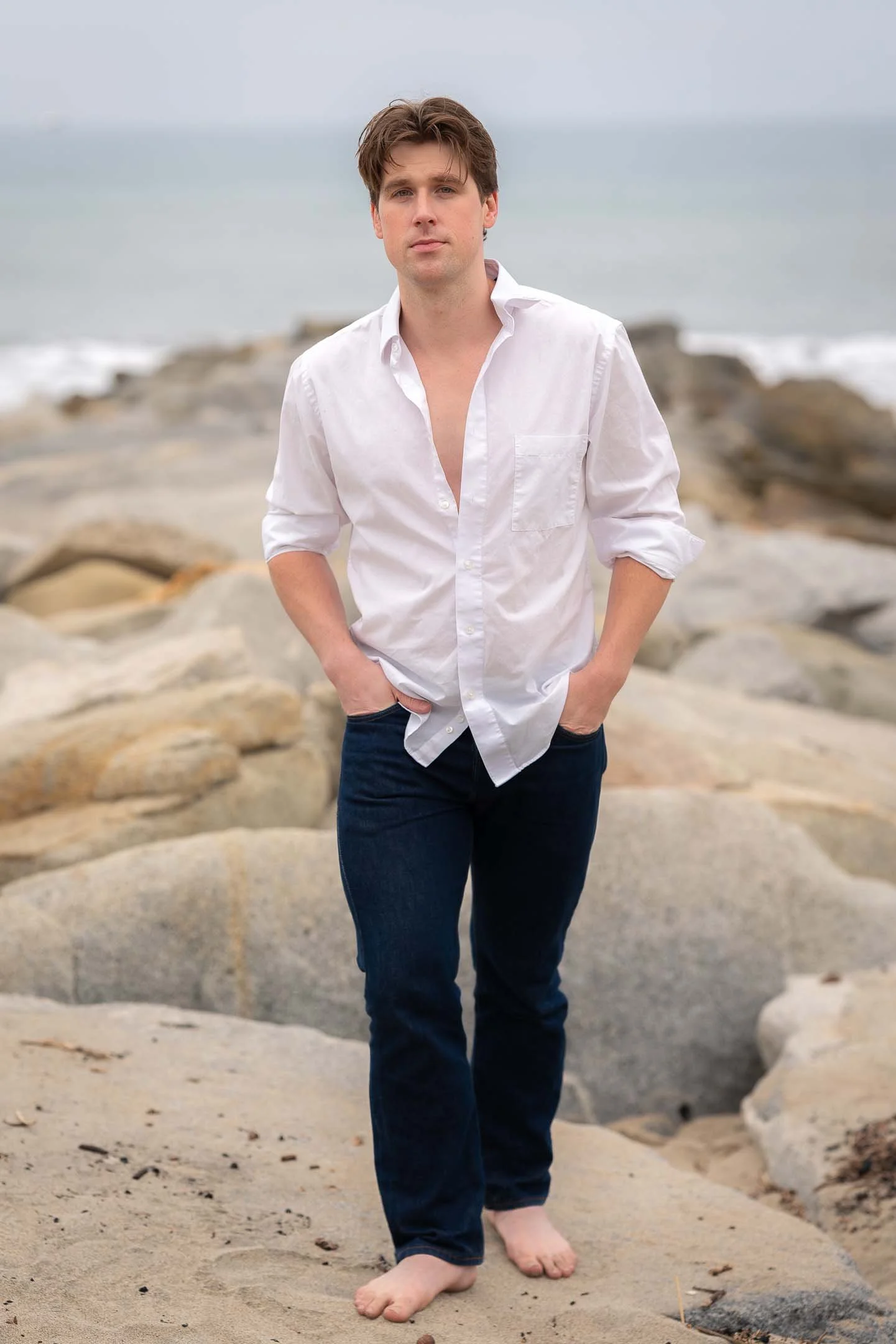 Los Angeles fashion model standing on the rocks at the beach