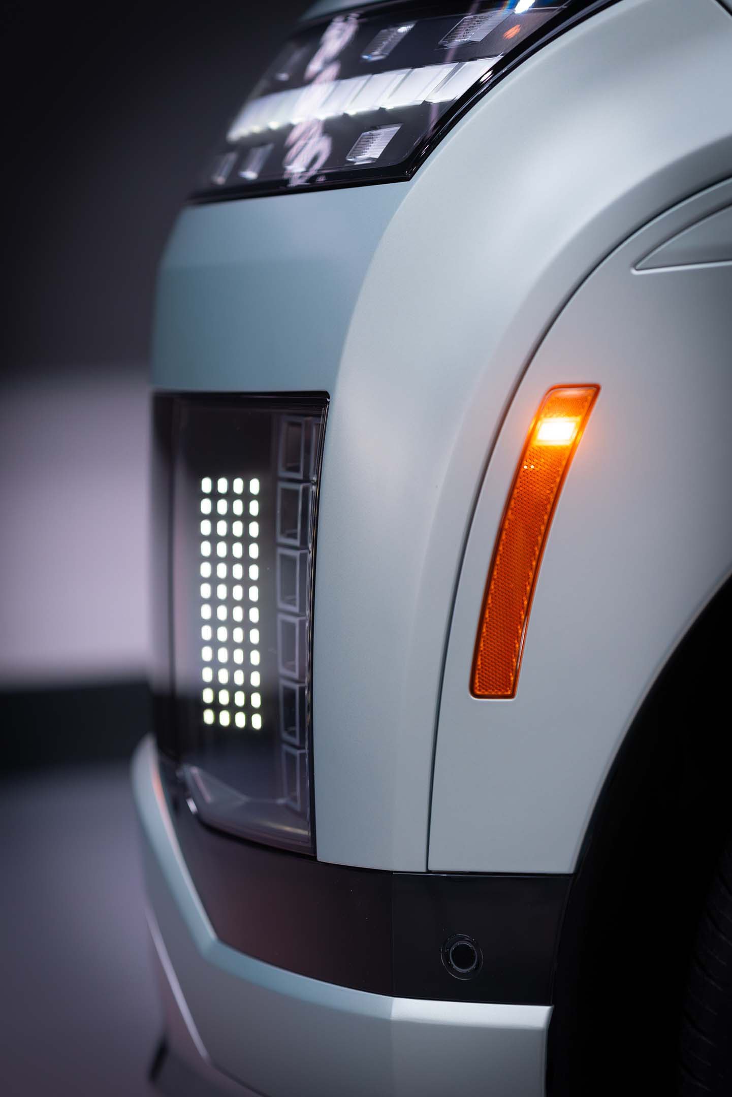Close up of white car from the side with orange lights