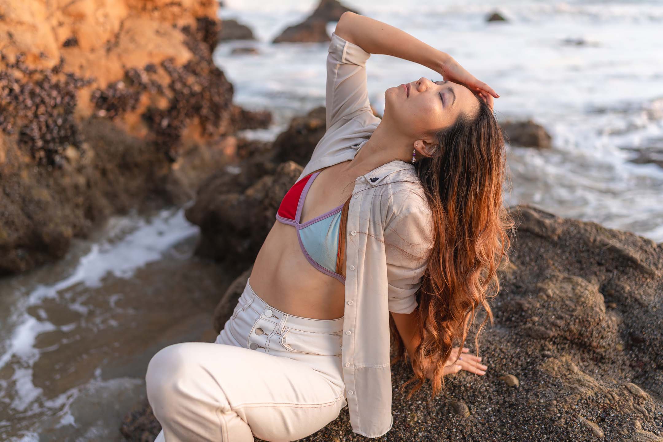 Los Angeles fashion model posing on rocks at El Matador Beach in Los Angeles
