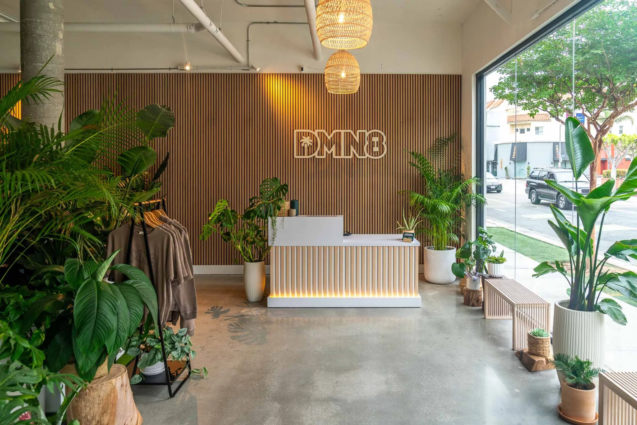 Interior gym featuring wood panels, reception desk, and greenery in Santa Monica