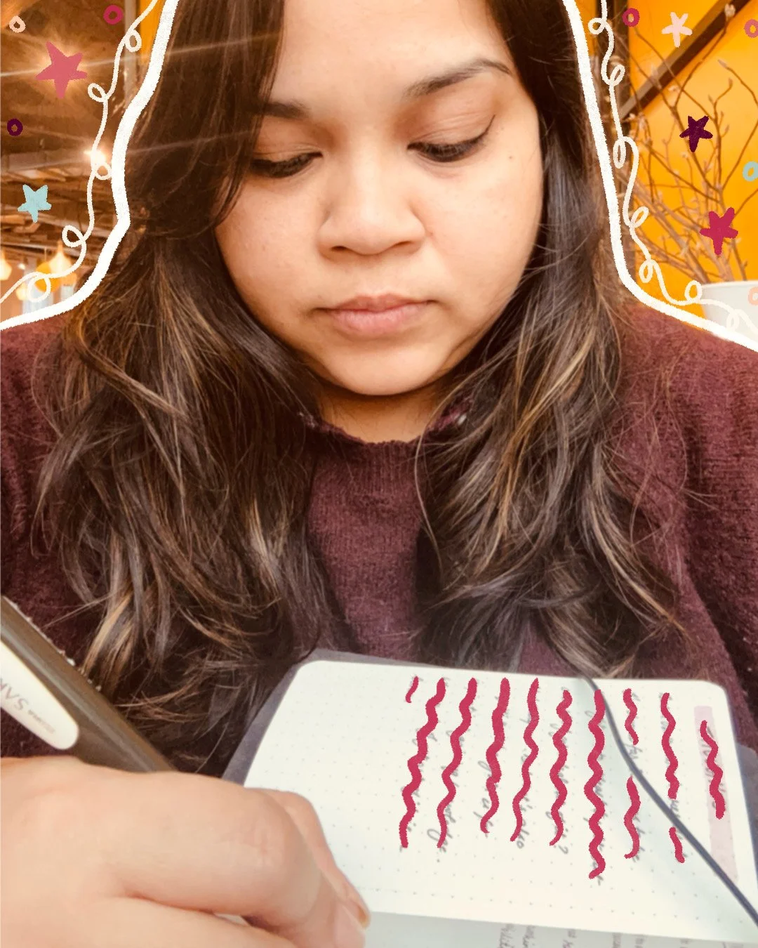 Anwesha writing in her notebook at a cafe in Rotterdam, the Netherlands