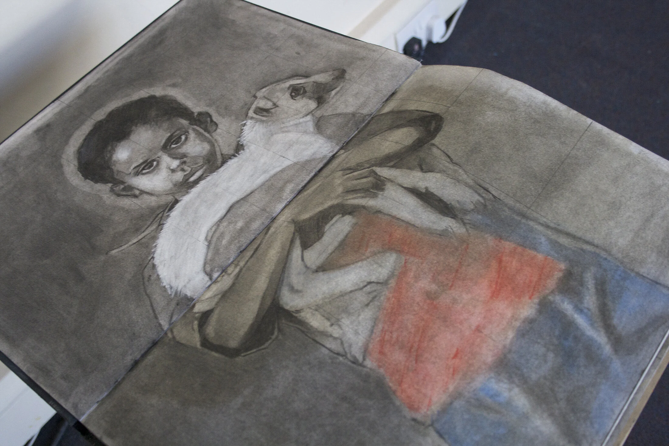 A drawing of a woman holding a baby, with both looking directly at the viewer, in a monochromatic style with some red color at the bottom.