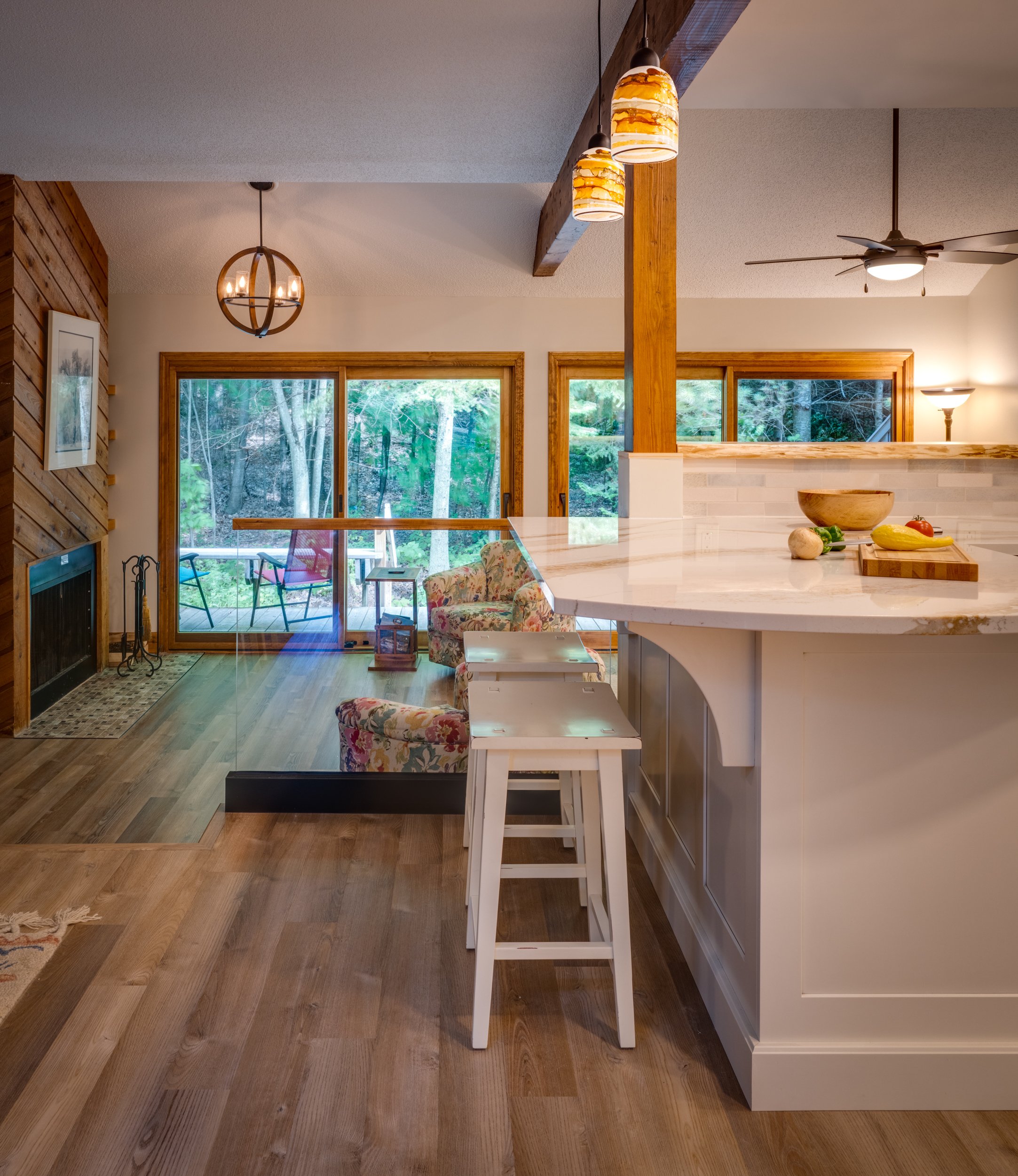 Kitchen island with the fireplace and a view of the woods in the background in a small condo near Harbor Springs, MI
