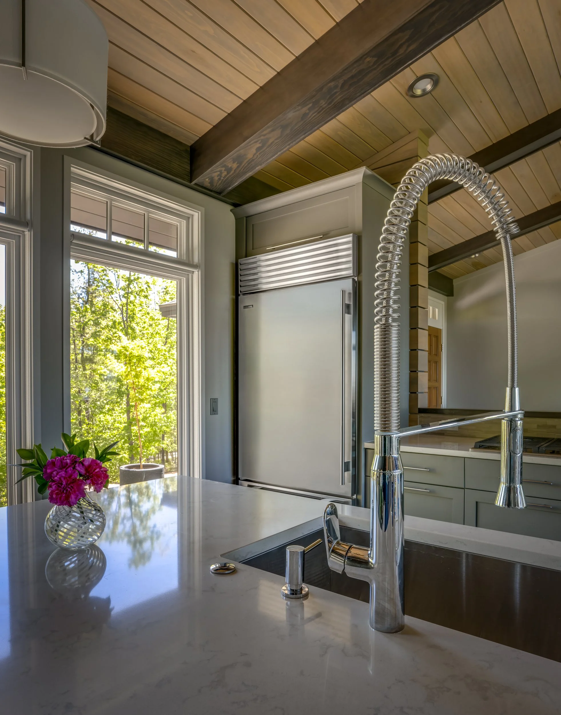 Subzero refrigerator past a Grohe island sink faucet.
