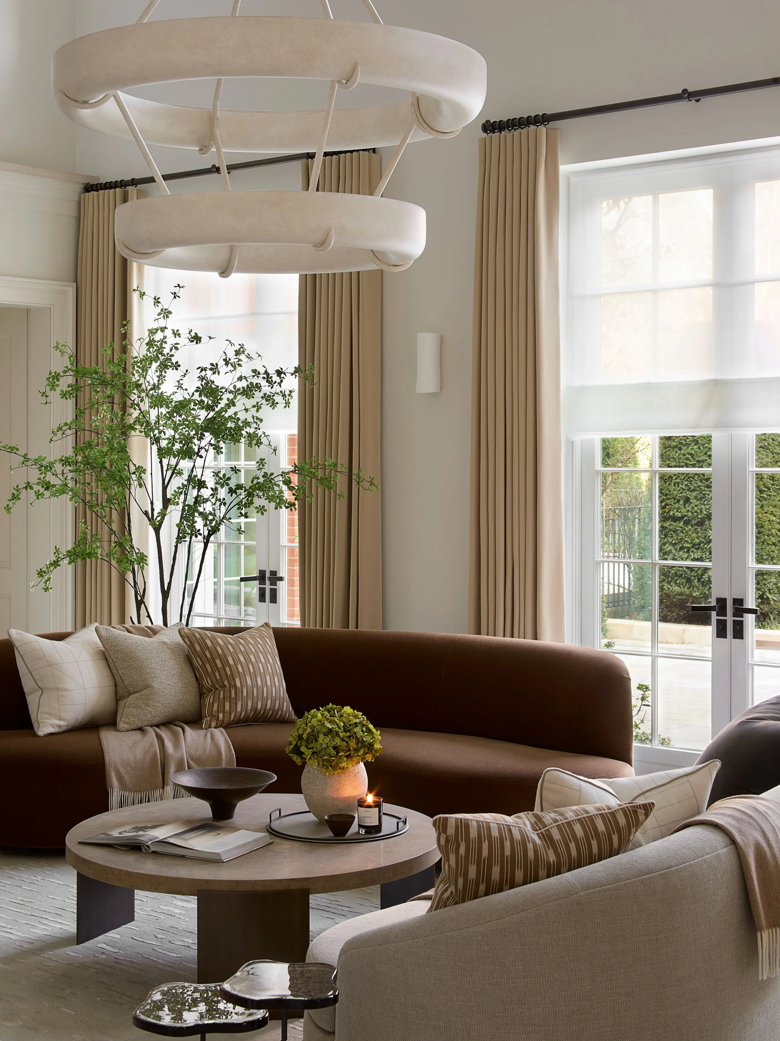One of my favourite rooms we&rsquo;ve ever designed. The living room at our Hampstead project is a celebration of fluid shapes, sculptural curved sofas, marble console tables and a stunning double-tiered plaster chandelier, all coming together to cre