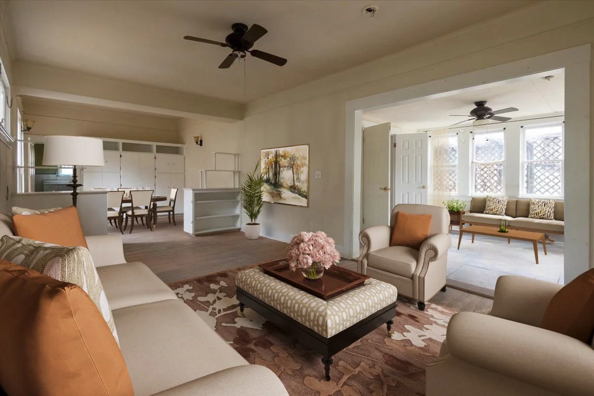 Living room with beige and brown furniture, a large sofa, armchairs, a coffee table with pink flowers, a patterned rug, and a dining area in the background. There are ceiling fans and large windows with lattice patterns.