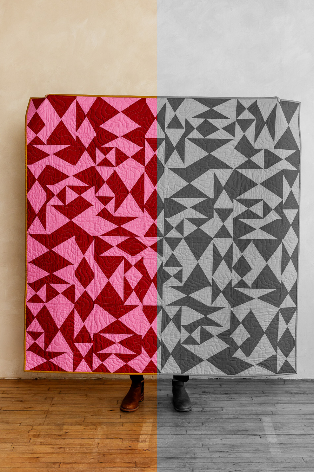 Improv quilt shown in red and pink on one side and grayscale on the other, illustrating medium contrast.