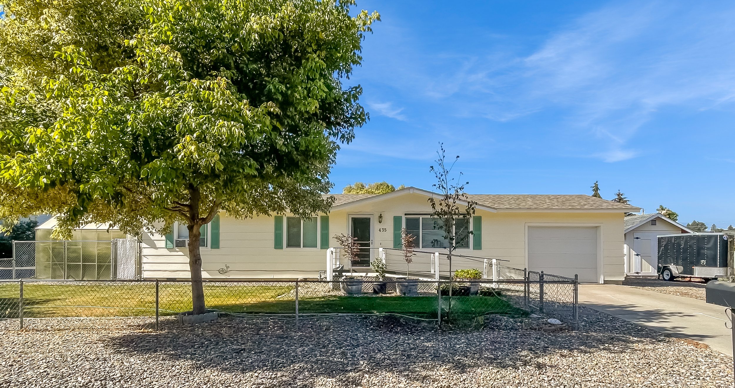 It includes endless extras with a covered, screened in deck, a green house, chicken coop and large shed.