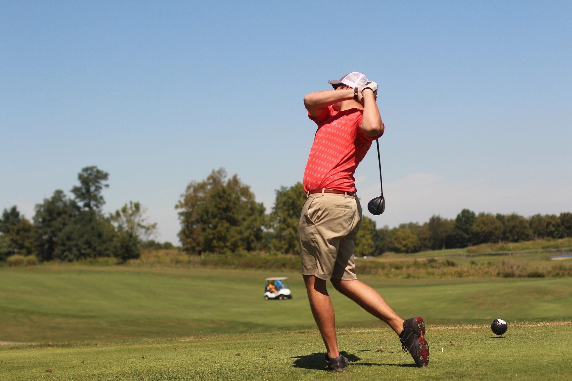 Adults male spine rotation in the follow through of his golf swing.