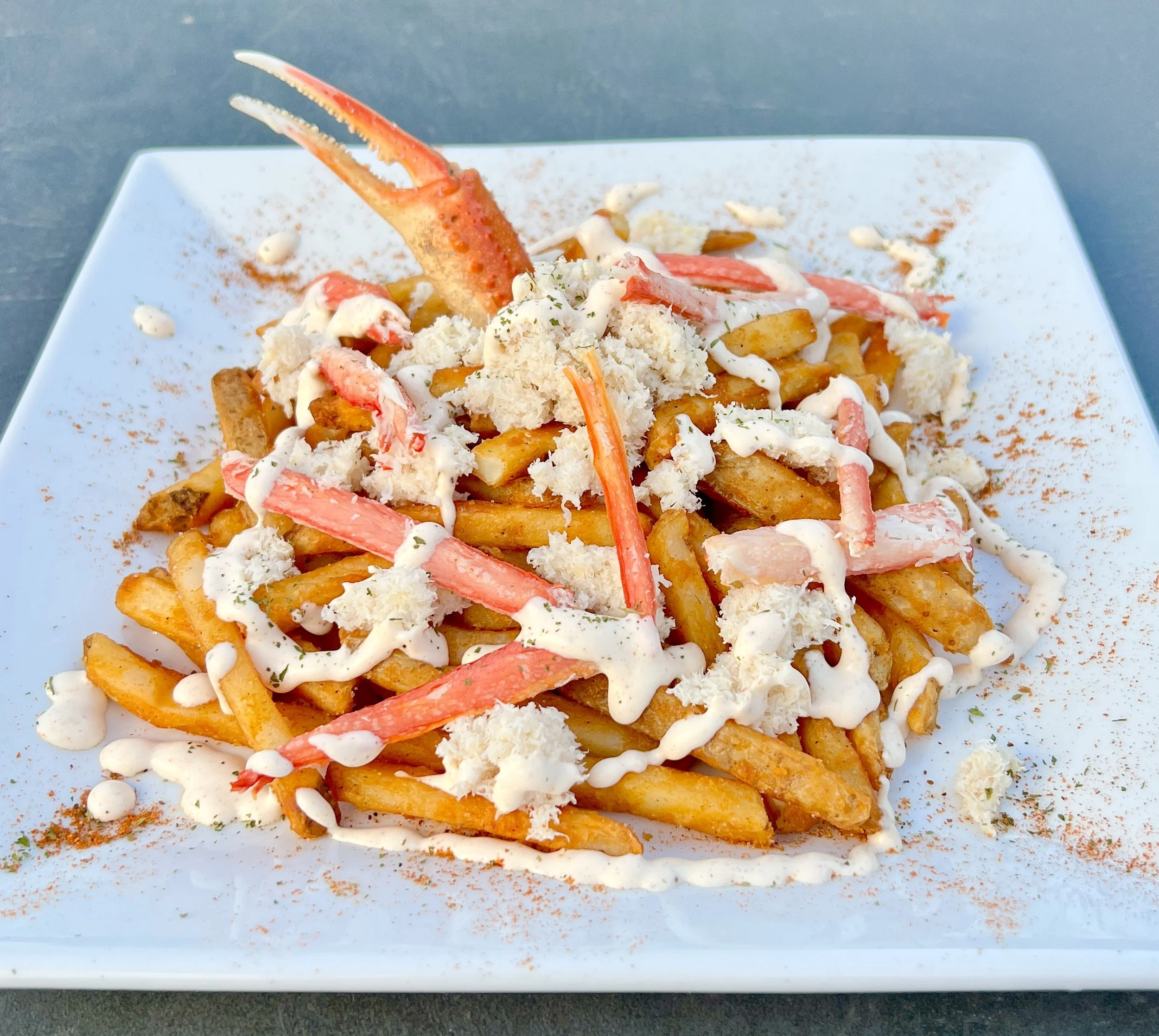Plate of french fries covered in crab and cream sauce