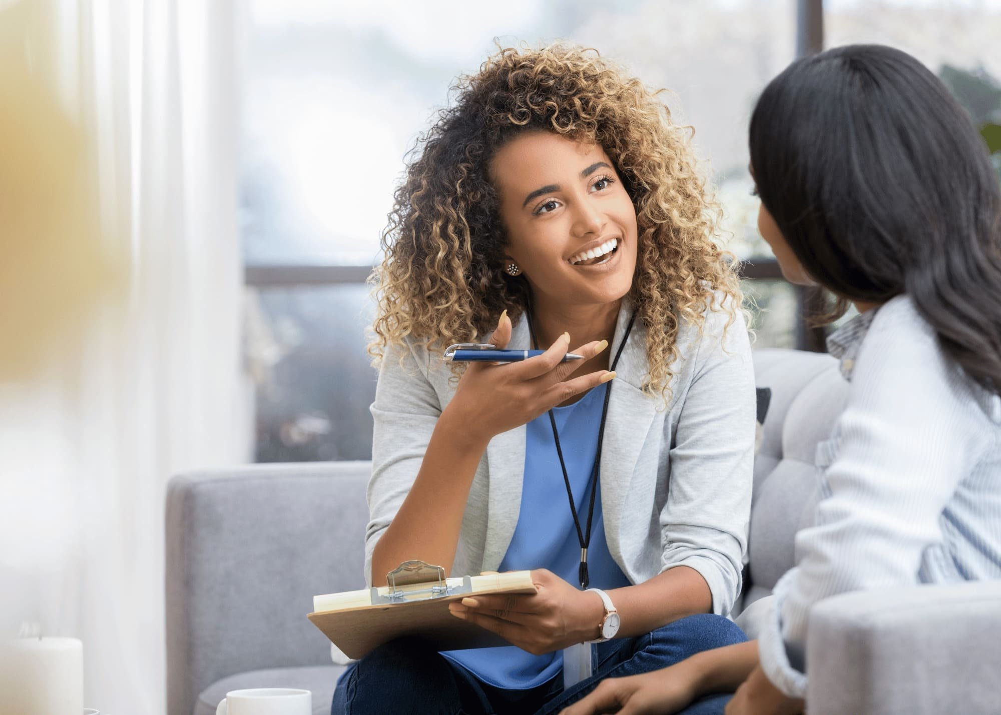 Therapist talking to another therapist in an office.