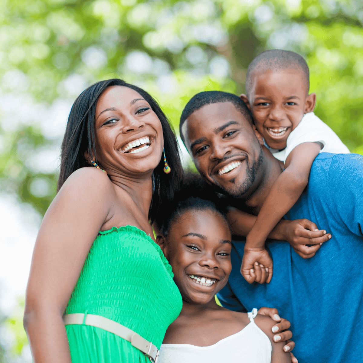 A smiling family with mother, daughter, son, and father.