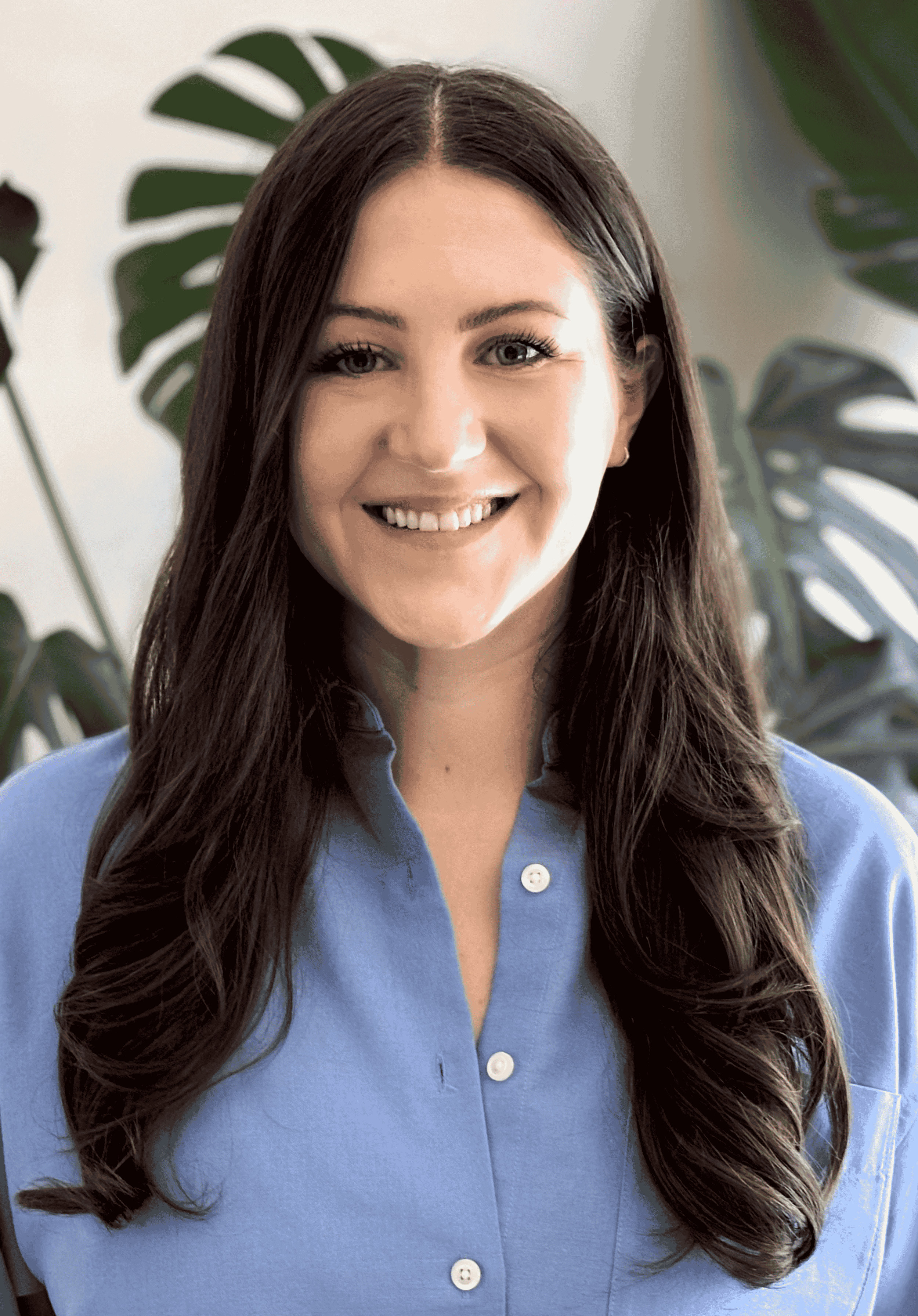 A woman with long brown hair wearing a blue shirt
