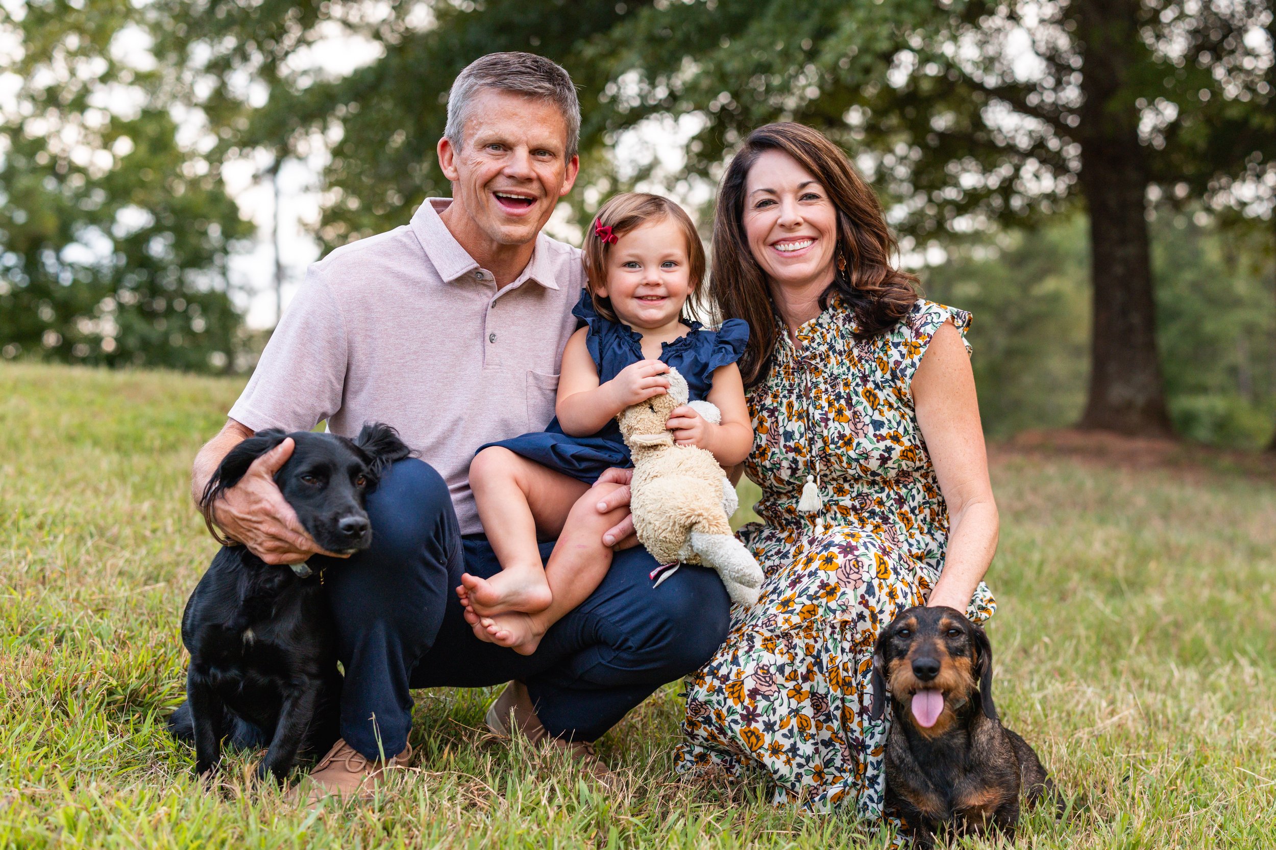 Megan and Daniel Lichty with their daughter, Margaret Rose, and family dogs