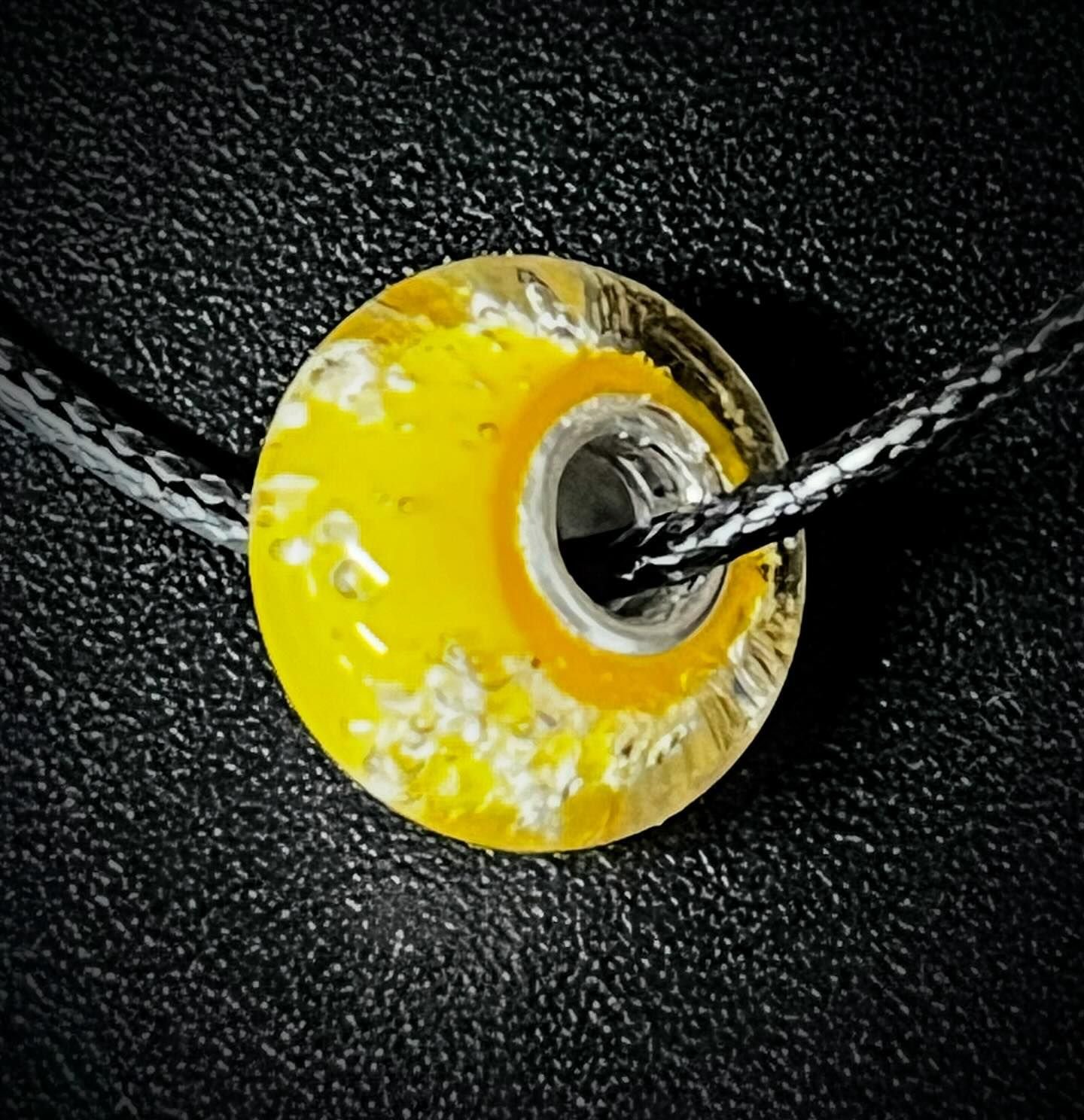 Yellow glass memorial bead made with pet ashes