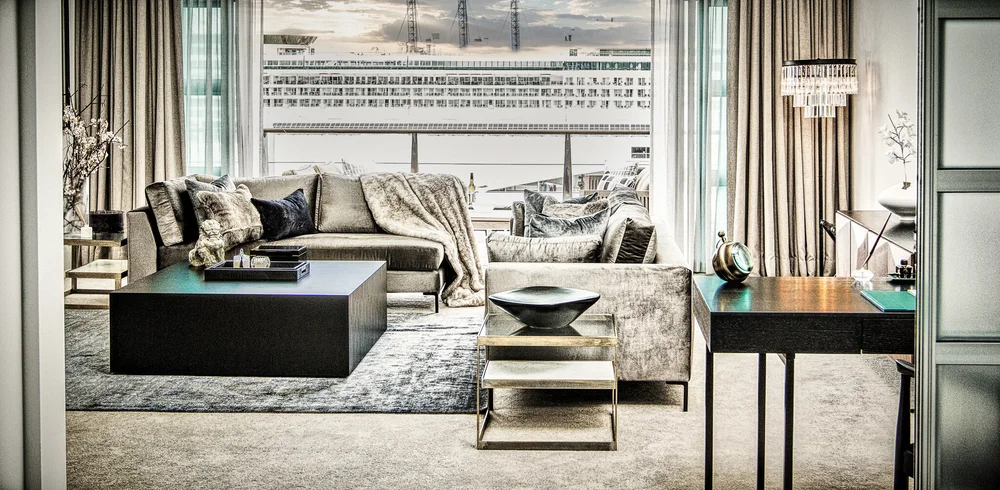 Living room overlooking Auckland harbour through full-height glazing.