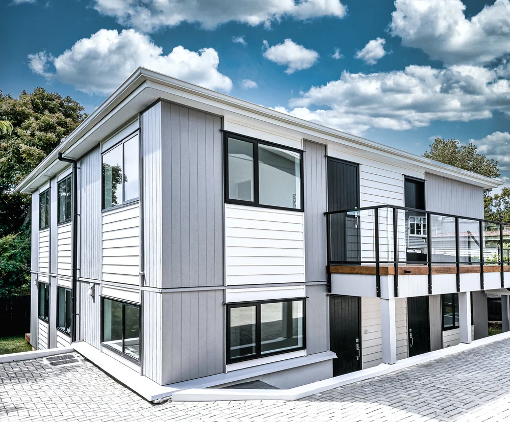Mt Wellington townhouse exterior with pale cladding and dark trim.