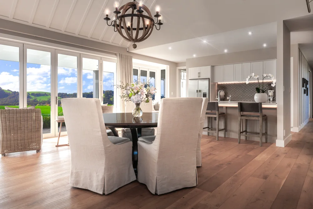 Dining area with slipcovered chairs beside the country kitchen.
