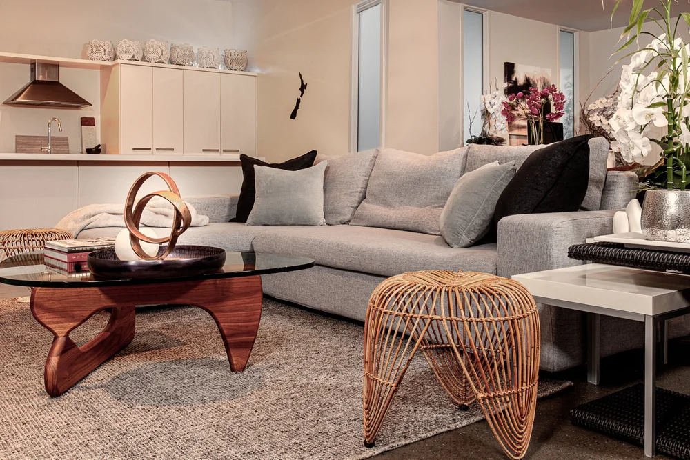 Comfortable lounge seating with woven side table and textured rug.