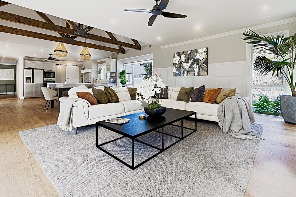 Formal living room with pale sofas and a dark coffee table.