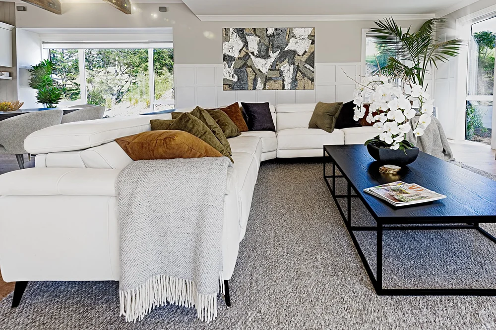 Pale seating and original art in the formal lounge.