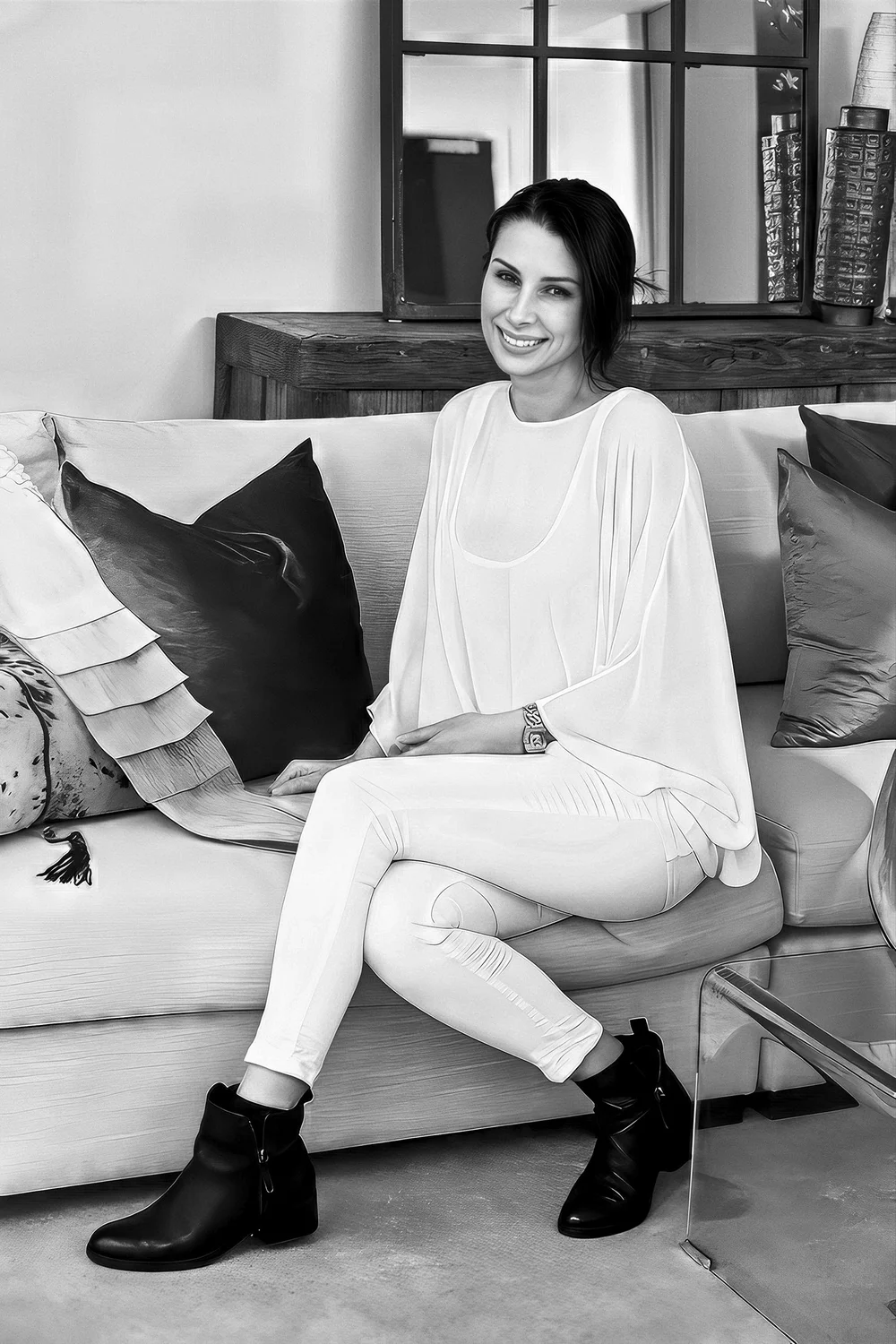 Shanly Simpson, New Zealand interior designer and artist, seated on a sofa.