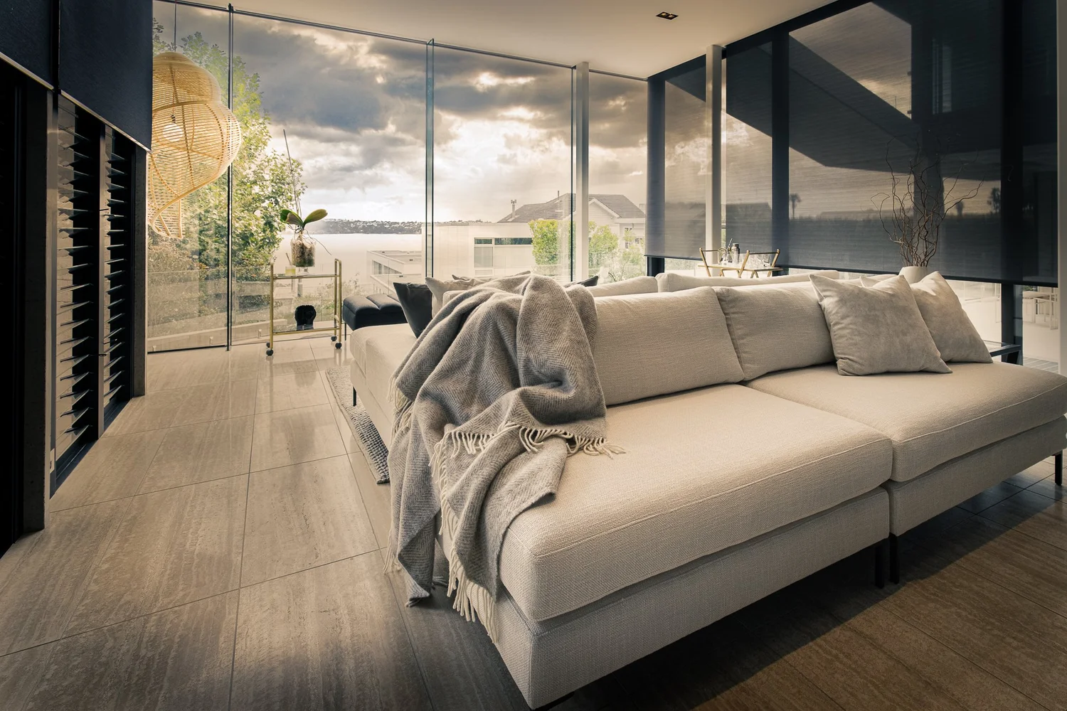 Custom double-sided cream sofa beside sea-facing windows in Herne Bay.