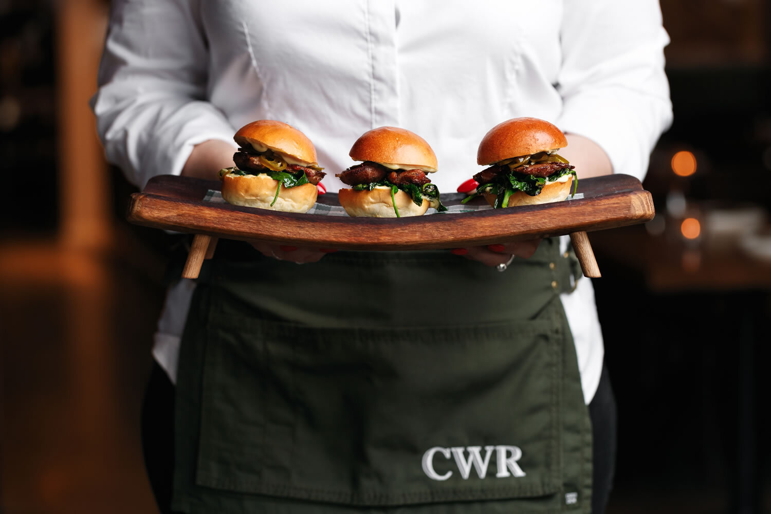 Waitstaff holding sliders