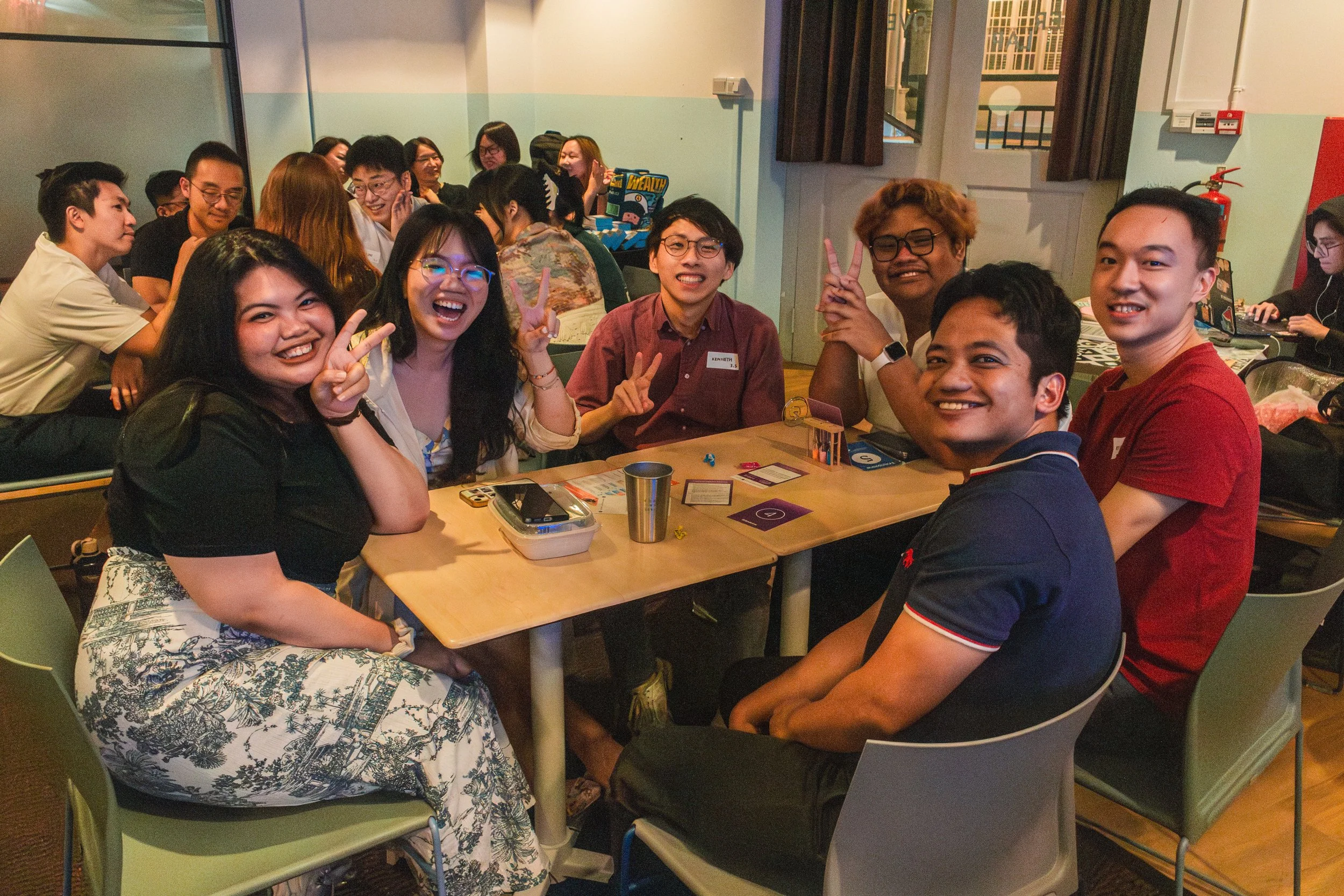 A group of six people cheerfully posing for a photo.