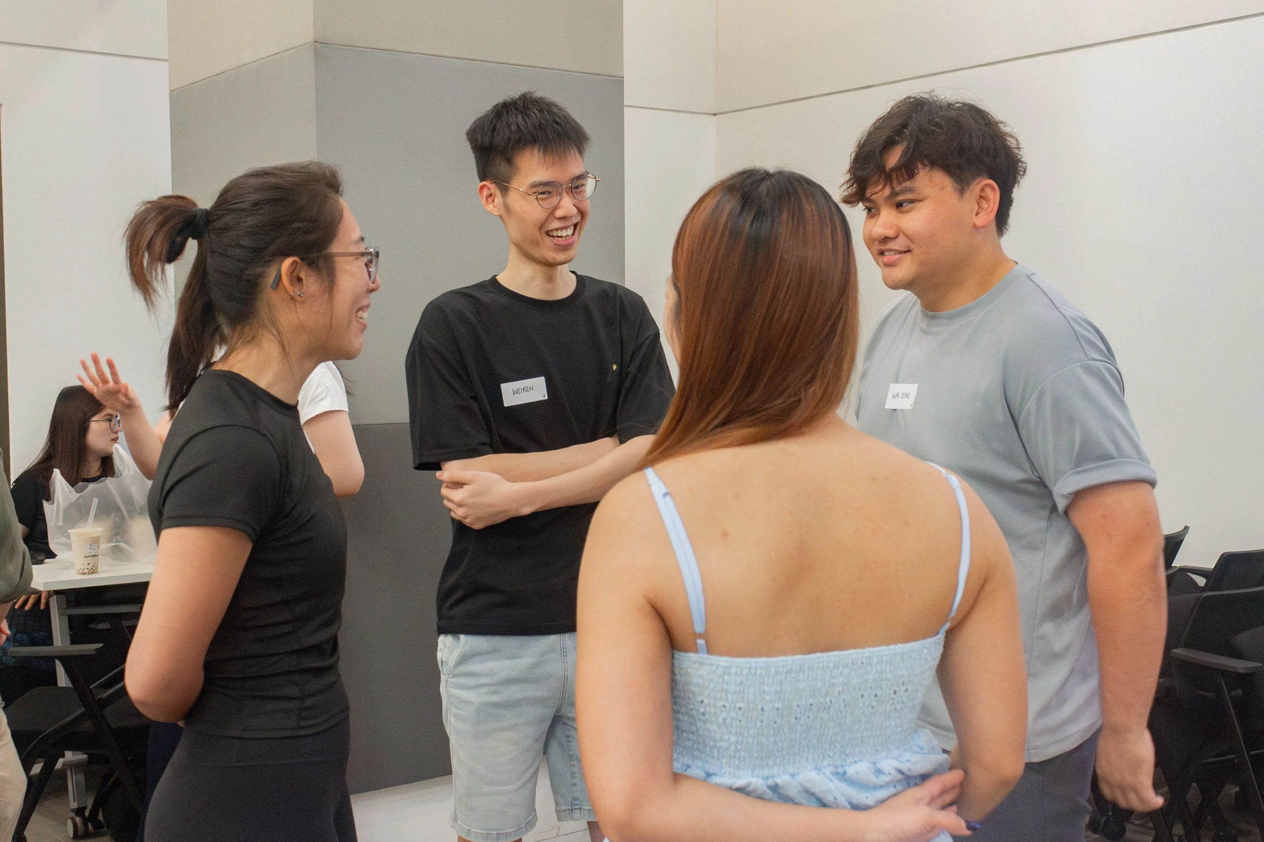 Four friends in a group happily chatting with one another