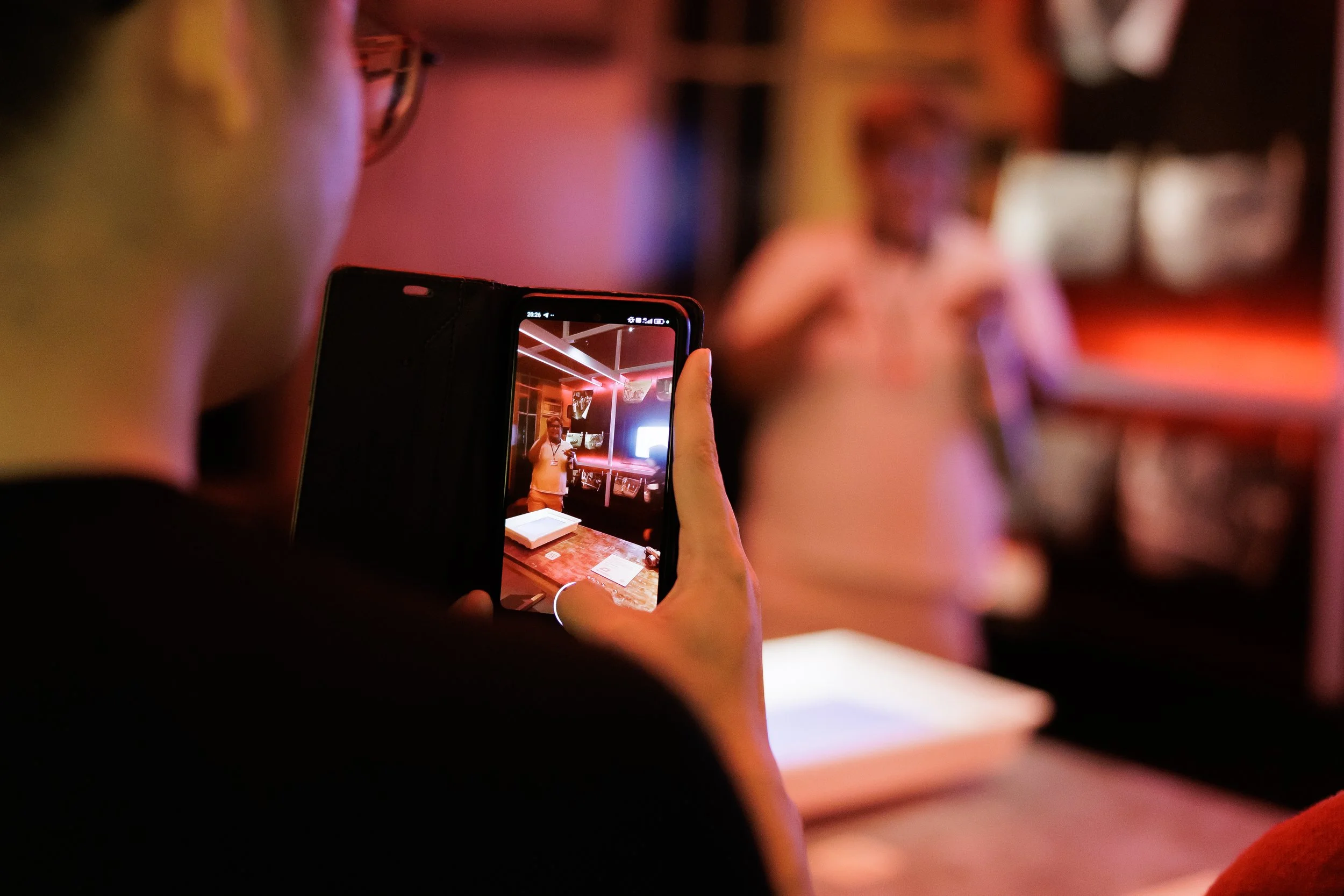 A participant capturing the moment during the exhibition walkthrough.