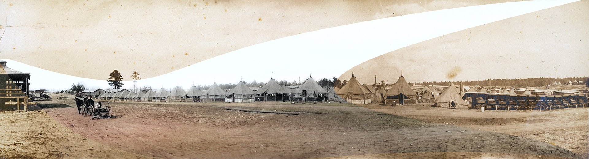 historical military camp with tents and horse-drawn carriage