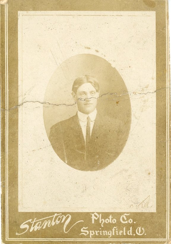 Vintage portrait photograph of a man in a suit, with "Stanton Photo Co. Springfield, O." printed on the bottom of the card.