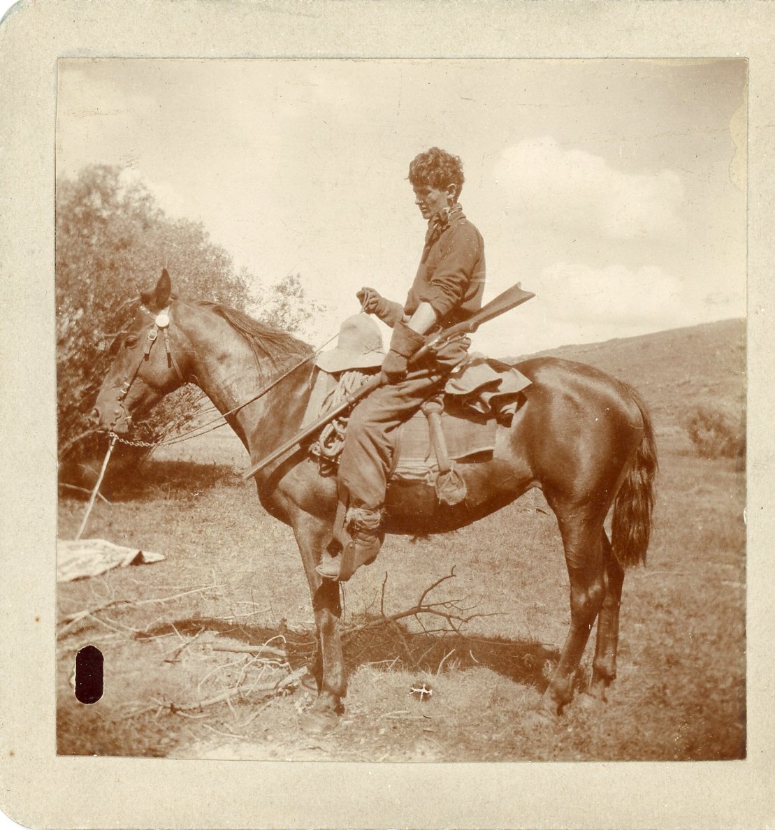 Vintage photo of person on a horse with rifle