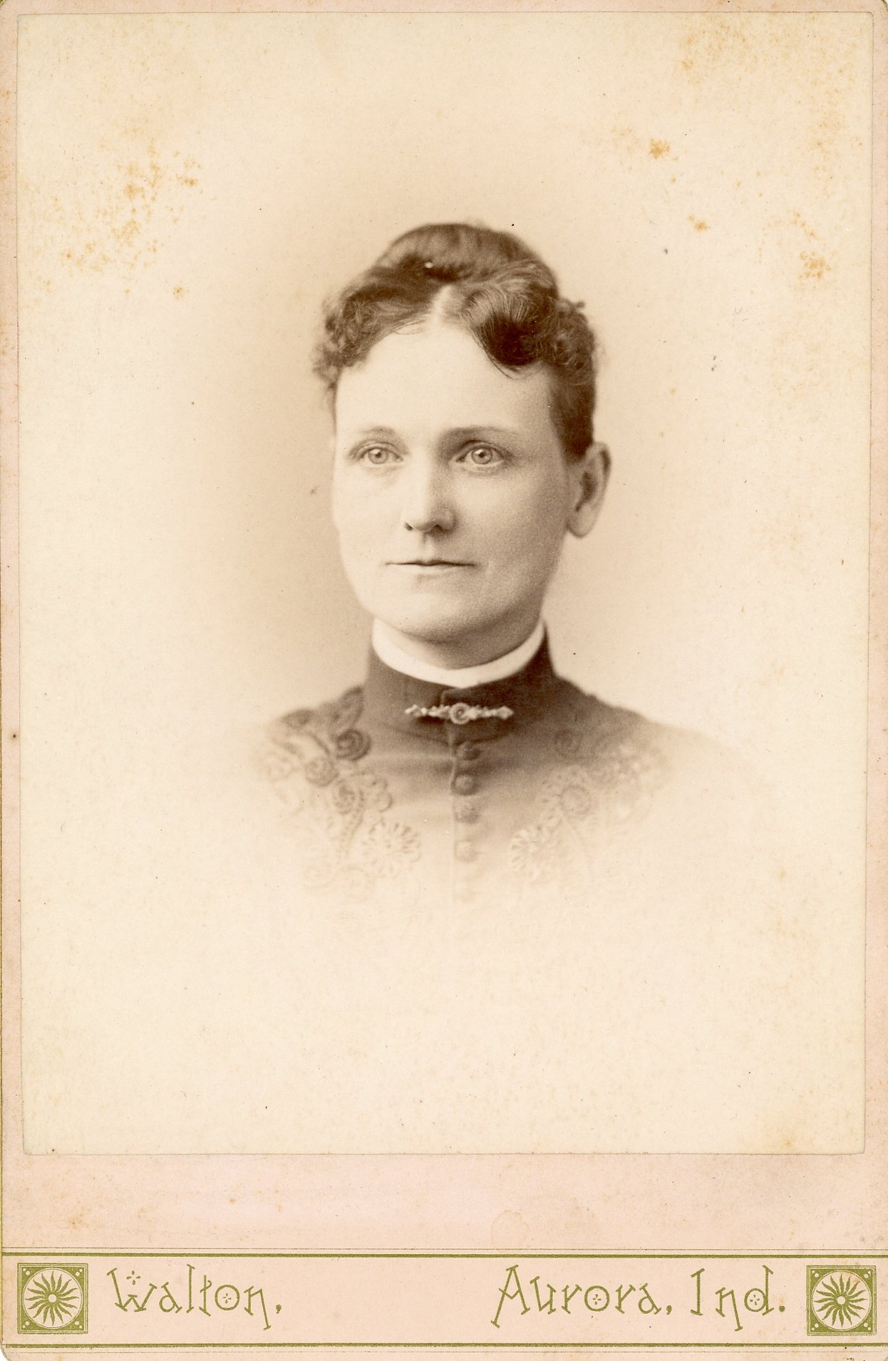 Vintage portrait of a woman in a high-collared dress, late 19th or early 20th century.