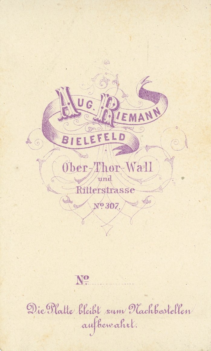 Vintage German business card design for Aug. Riemann Bielefeld with ornate purple typography and decorative elements.