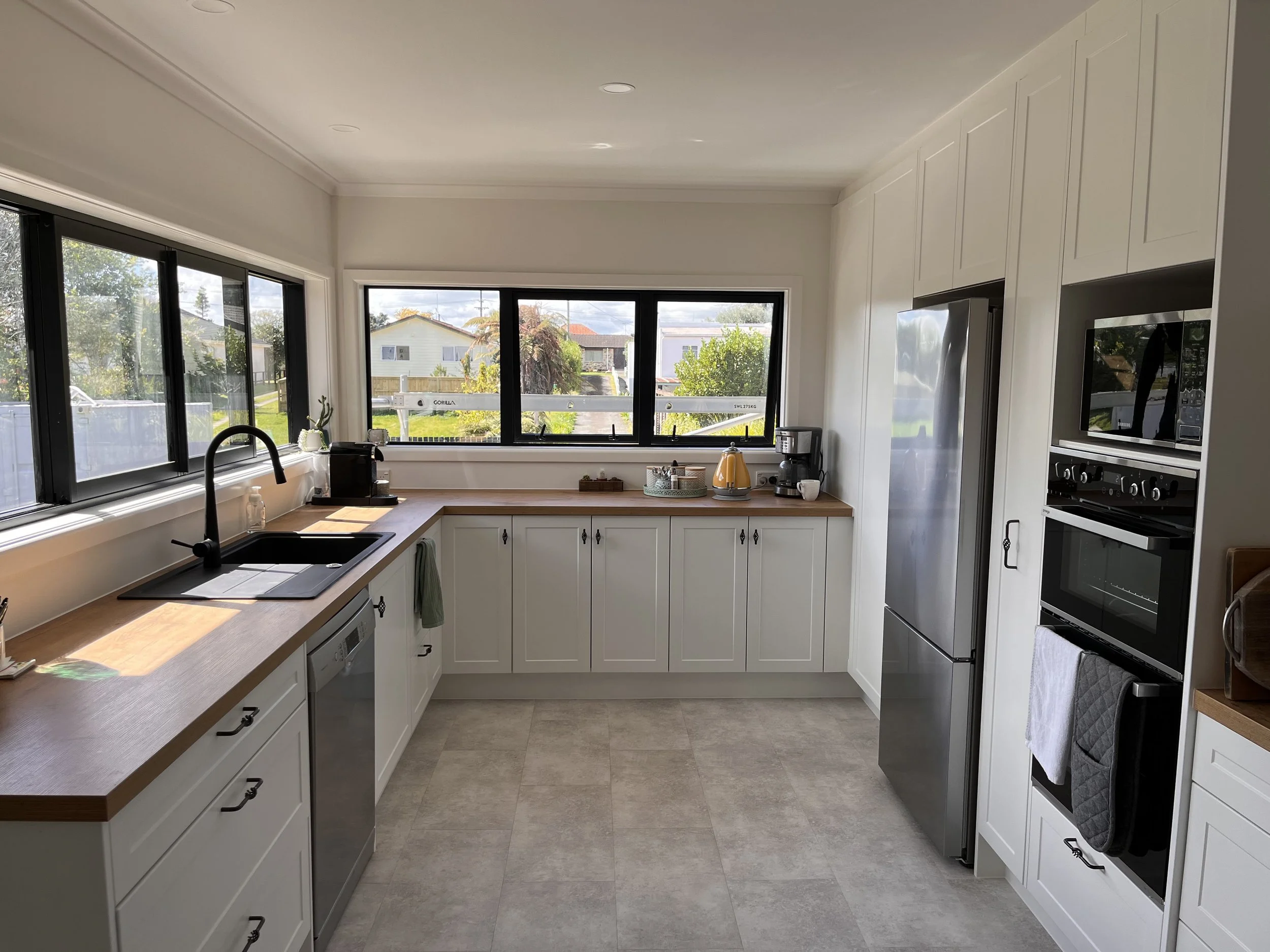 Full kitchen renovation, new vinyl flooring, black fixtures and modern cabinetry