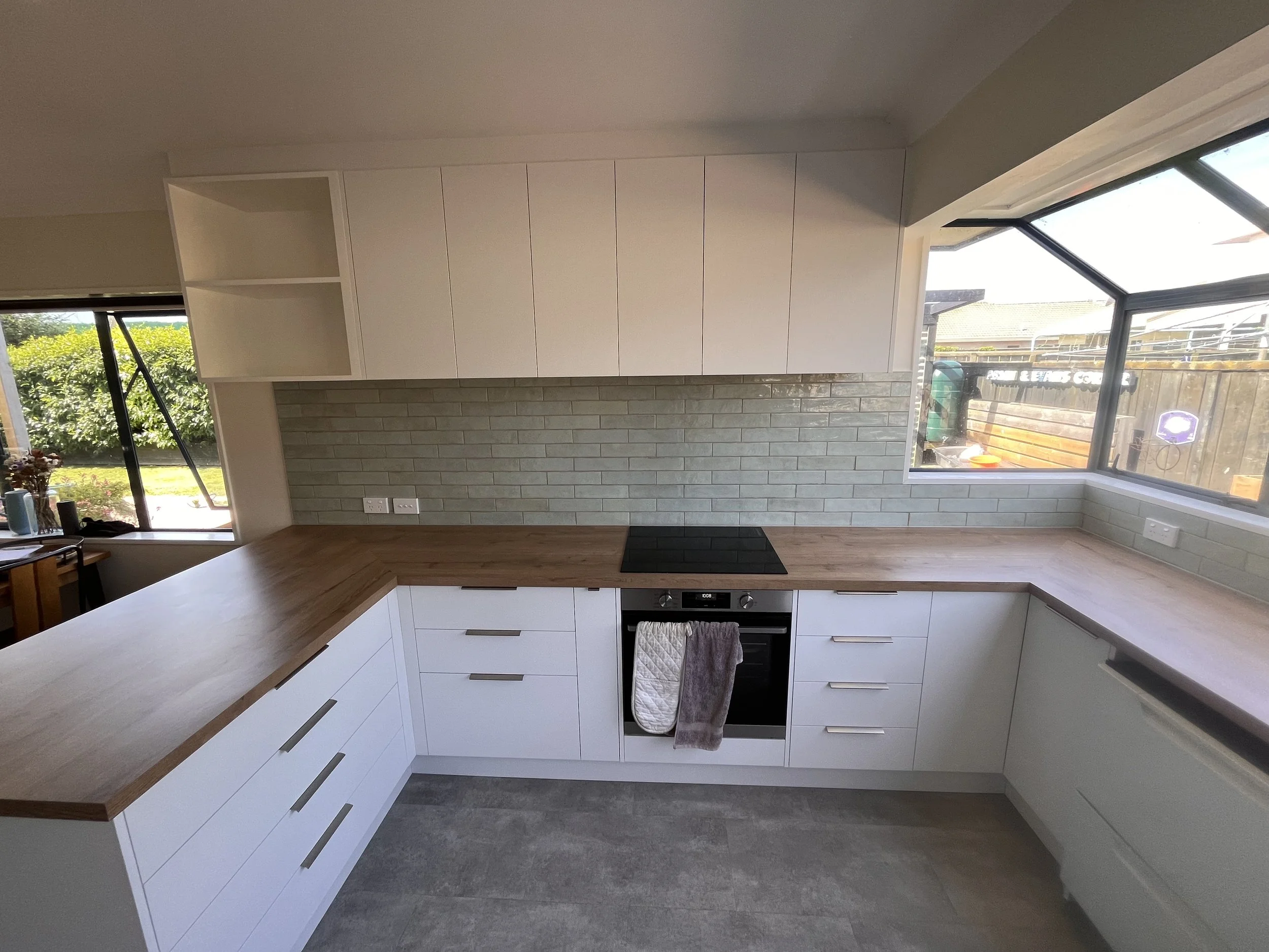 Kitchen renovation with ample cupboard, drawer and overhead storage. Sleek cabinetry with modern colour palette 