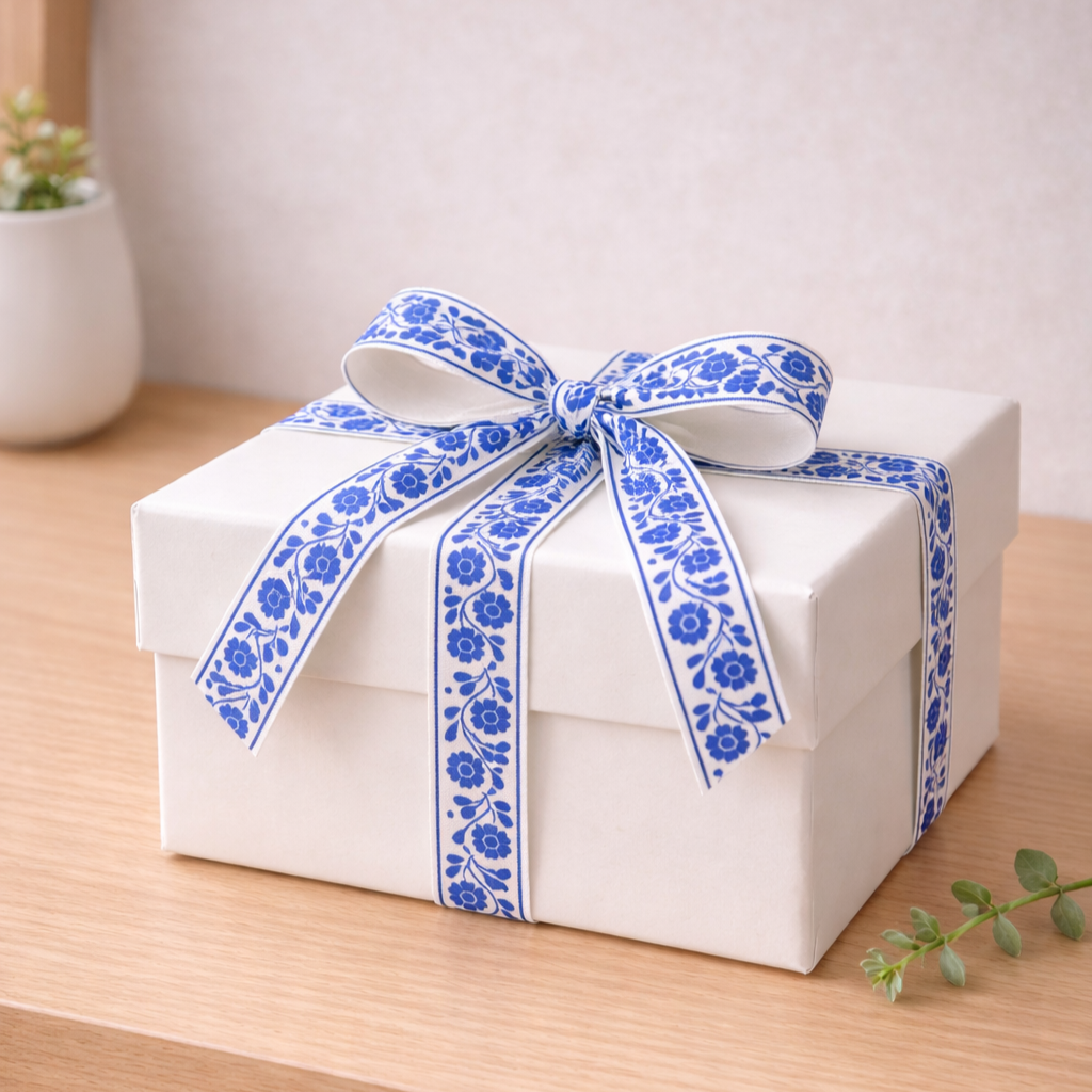 Blue+Floral+Cotton+Ribbon+White+Gift+Box+on+Desk.png