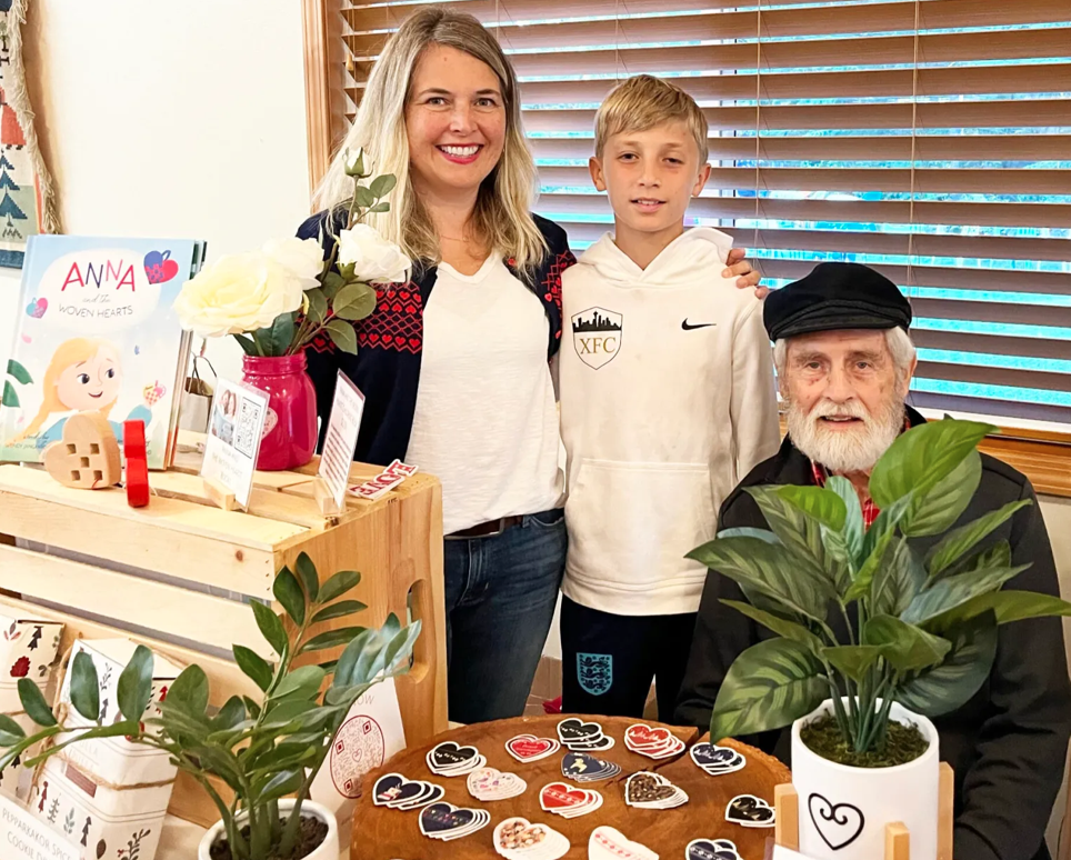 Wendy Jensen (left), her son, Cole (center), and Wendy’s dad, Loren Jangaard (right), are proud to display the Scandinavian Hearts product line.